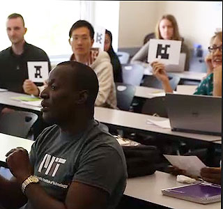 Students holding up cards with images on them that can be scanned as voting devices. Students holding up cards with images on them that can be scanned as voting devices.