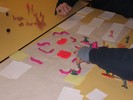 Several pieces on the board feature small dots of hot pink goo on them; off the board, pieces with lots of pink dots are presumably dead.