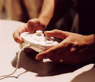Playing with a handheld video game controller. Playing with a handheld video game controller.