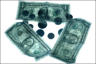 Three US dollar bills and various coins. Three US dollar bills and various coins.