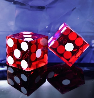 Two red dice on a surface. Two red dice on a surface.