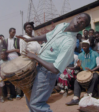 People dancing and playing drums. People dancing and playing drums.