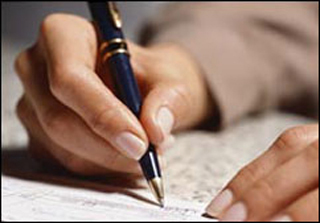 Photograph of a hand holding a pen and writing on a piece of paper. Photograph of a hand holding a pen and writing on a piece of paper.