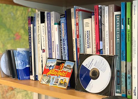 German textbooks and cds on book shelf.