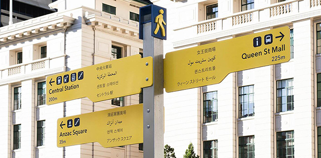 Brightly colored signs have 5 different languages written on them. Brightly colored signs have 5 different languages written on them.