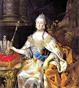 A serene-looking, grey-haired woman, adorned in a colorful, low-bodiced robe, sits on a throne, with a scepter in her hand. A serene-looking, grey-haired woman, adorned in a colorful, low-bodiced robe, sits on a throne, with a scepter in her hand.