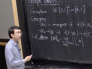 A man standing next to a blackboard. A man standing next to a blackboard.