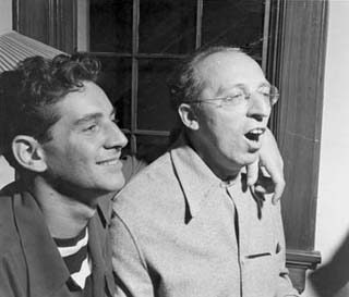 Candid photo: Bernstein's arm around Copland's shoulder; Copland singing. Candid photo: Bernstein's arm around Copland's shoulder; Copland singing.