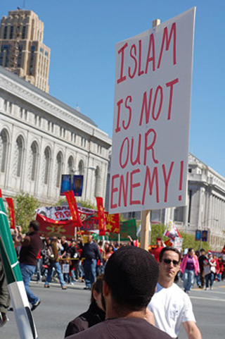 Protestor holding a sign - Islam is not our enemy! Protestor holding a sign - Islam is not our enemy!