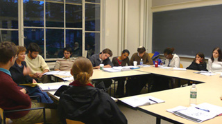 Photograph of instructor and students engaged in class discussion. Photograph of instructor and students engaged in class discussion.