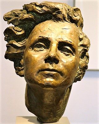 A bronze bust of a woman with strong features and wavy hair. A bronze bust of a woman with strong features and wavy hair.