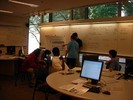 A teacher stands at an easel explains invsible light to a student.