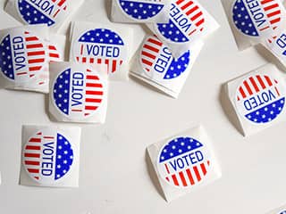 Small stickers with the words "I Voted" printed amongst the stars and stripes. Small stickers with the words "I Voted" printed amongst the stars and stripes.