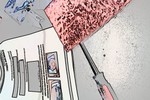 A blurry photo of papers, a screwdriver and a sponge on a table.